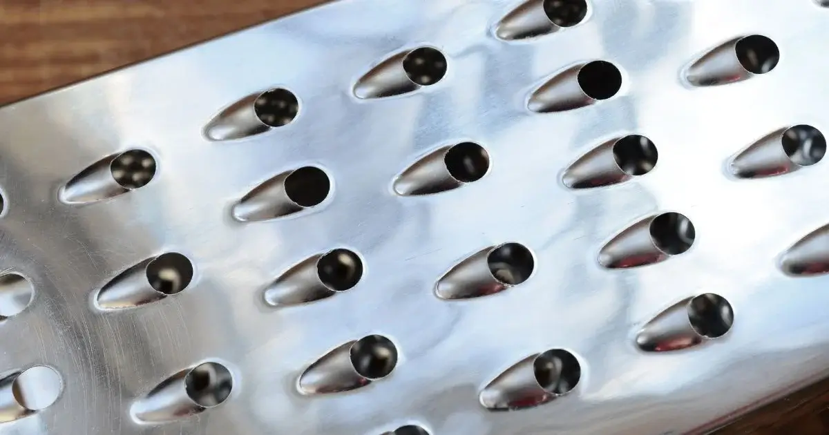 Close-up of precision stamped perforated metal sheet